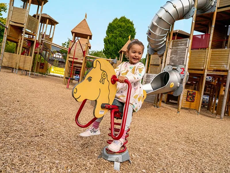 small girl on playground attraction